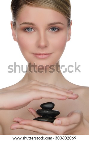 Beautiful woman holding black stones in hand isolated on white