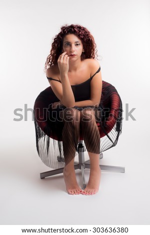 pretty girl sitting on a red chair