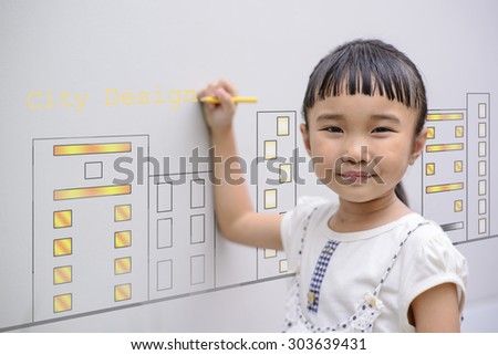 Kid Drawing city design on grey wall background