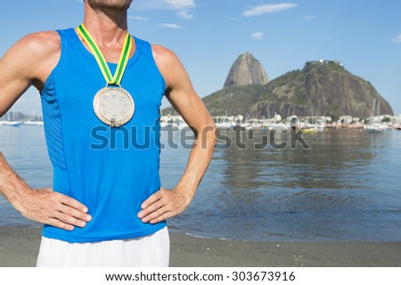 Frst place athlete wearing gold medal standing outdoors at Botafogo Bay Rio de Janeiro Brazil 