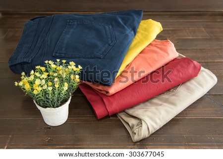 Set of clothes and various accessories for women on old wooden table