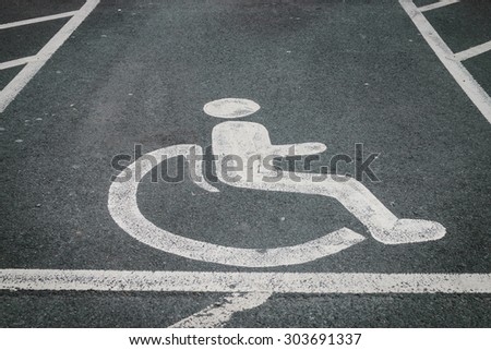 handicapped / disabled parking sign painted on the road asphalt 