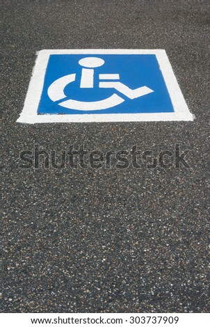 handicap, disabled parking sign painted on the asphalt