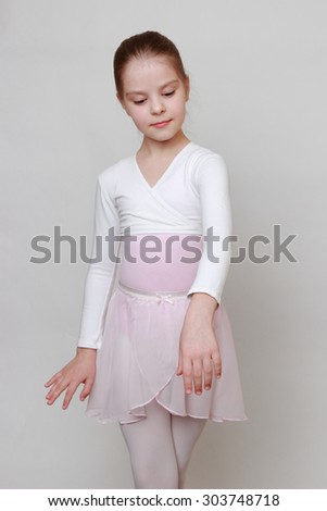 little ballerina in studio posing on camera