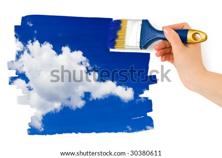 Hand with paintbrush painting sky isolated on white background