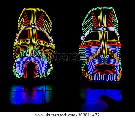 Different colors glowing neon indian masks installation