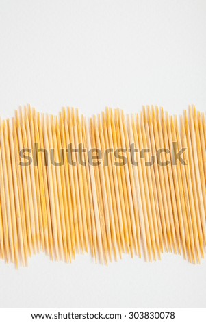 Bunch of toothpicks on white paper background