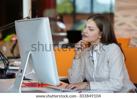 Young pretty business woman with computer in the office