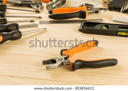 orange pliers on white table