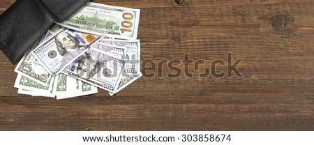 High Angle View Of Modern Black leather Men's Wallet With Dollar Cash On The Old Rough Wood Textured Background With Copy Space