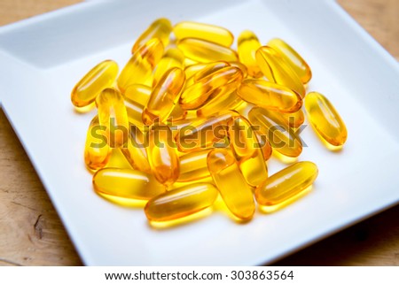 Bunch of fish oil capsules pills in plate