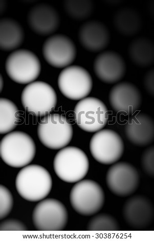 Beautiful black and white blurred lights on a dark background.
