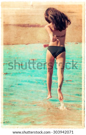 vintage style picture of a young girl running at a beach