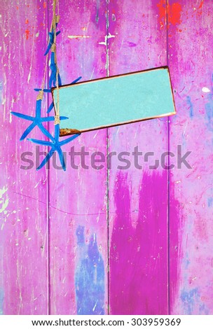 Pink colorful vintage background with shabby distressed grungy texture hippie style, blue sea stars  and turquoise metal plate for text message.