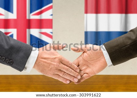 Representatives of the UK and the Netherlands shake hands