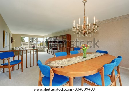 Modern dinning room with royal blue chairs, and carpet.