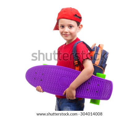 Smiling schoolkid standing with skateboard and backpack on white background