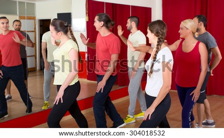 Happy people dancing in a gym indoors
