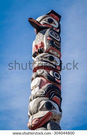 Part of a totem pole at the front entrance of the Icy Strait Point Hoonah Tlingit Cultural Center Theater near Hoonah, Alaska on Chichagof Island. Royalty-Free Stock Photo #304044800