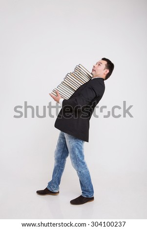 a man in business clothes carries books on a white background