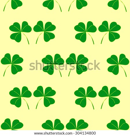 Vector seamless background with shamrocks on light yellow background