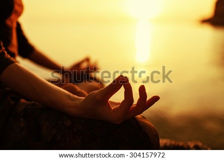 serenity and yoga practicing at sunset, meditation Royalty-Free Stock Photo #304157972