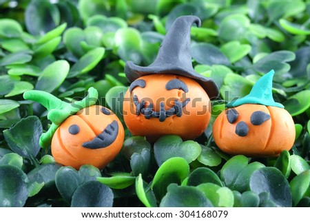 Halloween pumpkins on plastic grass 