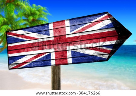 United Kingdom flag on wooden table sign on a beach background