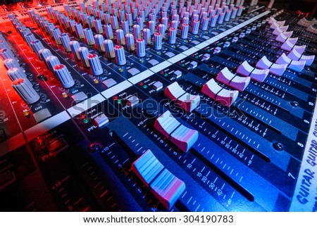 detail sound mixer in red and blue light with great perspective