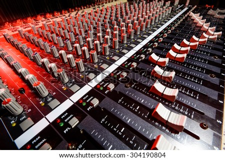 detail sound mixer in red and white light with great perspective