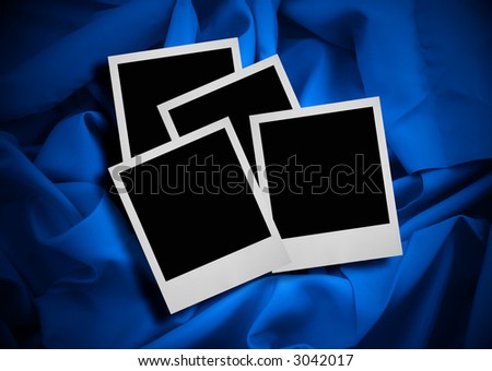 stack of photo frames against blue textile background