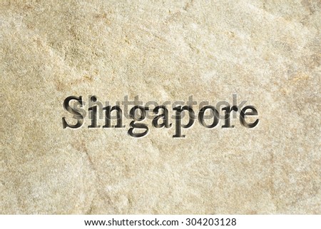 Engraving spelling the city Singapore on textured old surface
