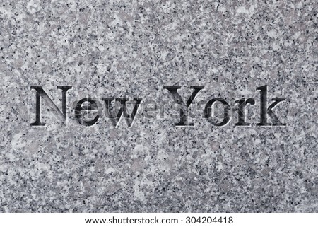 Engraving spelling the city New York on textured old surface
