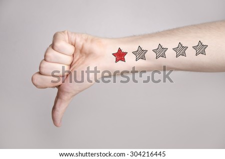 Man hand showing thumbs down and one star rating on the arm skin. Dislike Royalty-Free Stock Photo #304216445