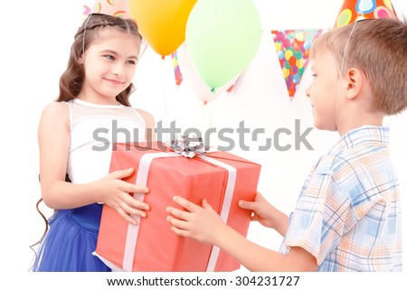 For my friend. Little cute boy is giving huge present to his beautiful female girlfriend.
