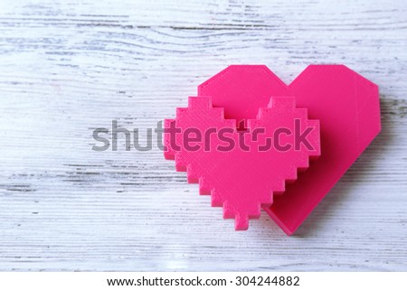 Plastic hearts on wooden background