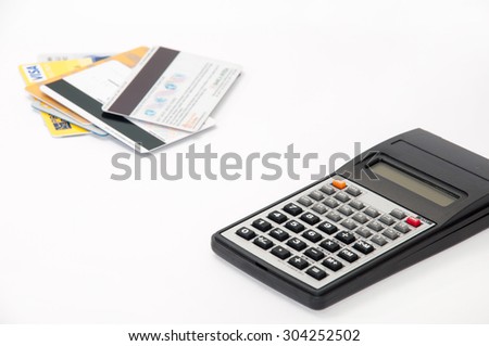 Calculator with credit cards in the background.