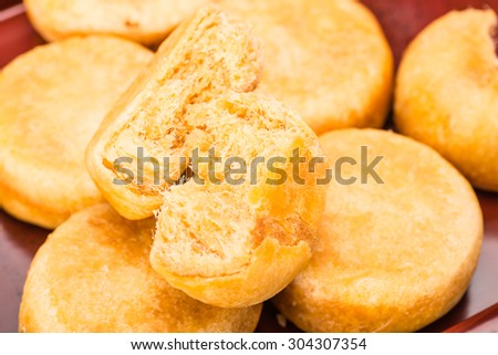 pie with meat wool, meat floss, pork floss, flossy pork, pork sung or yuk sung, is a dried meat product with a light and fluffy texture similar to coarse cotton, this pie is a dessert from China. Royalty-Free Stock Photo #304307354