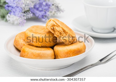 pie with meat wool, meat floss, pork floss, flossy pork, pork sung or yuk sung, is a dried meat product with a light and fluffy texture similar to coarse cotton, this pie is a dessert from China. Royalty-Free Stock Photo #304307357