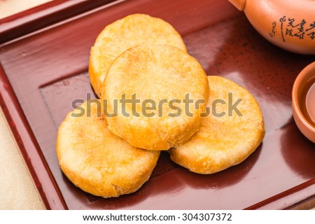 pie with meat wool, meat floss, pork floss, flossy pork, pork sung or yuk sung, is a dried meat product with a light and fluffy texture similar to coarse cotton, this pie is a dessert from China. Royalty-Free Stock Photo #304307372