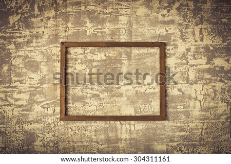 wooden frame on rough concrete wall
