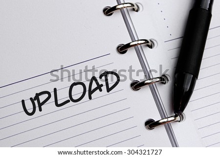 UPLOAD word written on notebook