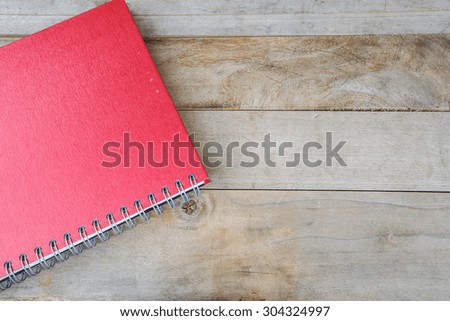 Red Notebook on  old wood  Backgrounds