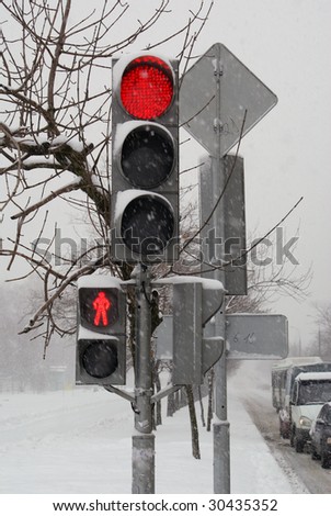 Traffic light and cars on the street in winter Moscow