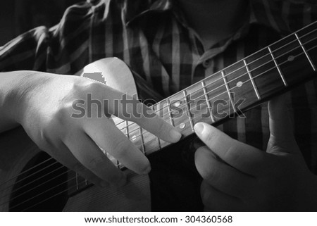 Playing guitar, Close-up shot. black and white tone