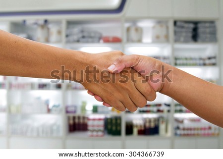 handshake in a business and deal in the pharmacy background
