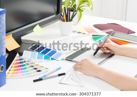 Graphic designer at work. Color swatch samples.