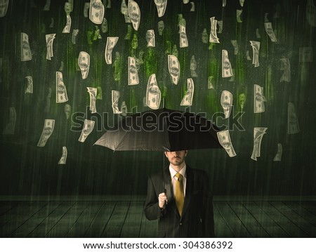 Businessman standing with umbrella in dollar bill rain concept on background