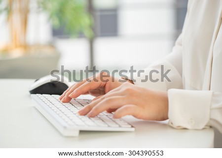 Hands of an office woman typing keyboard with credit card

