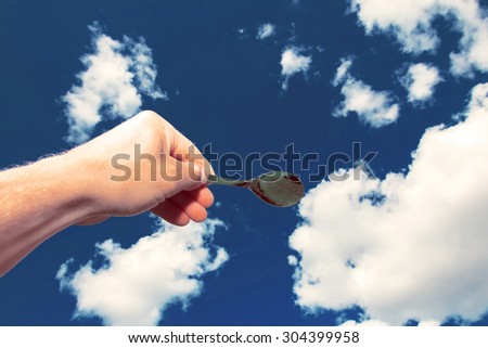 Spoon taking a piece of the cloud in Finland. Image includes a effect.